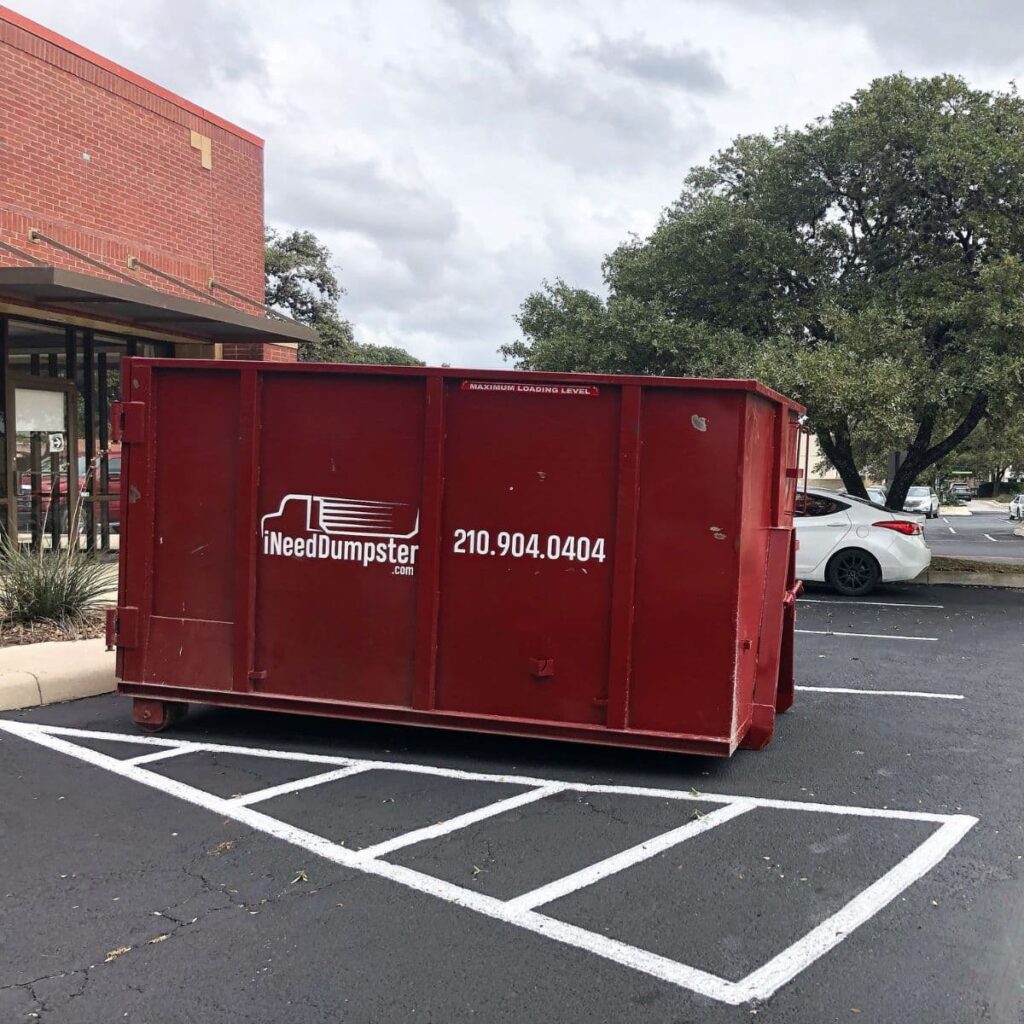 I Need Dumpster red dumpster sitting outside of a commercial building in san antonio